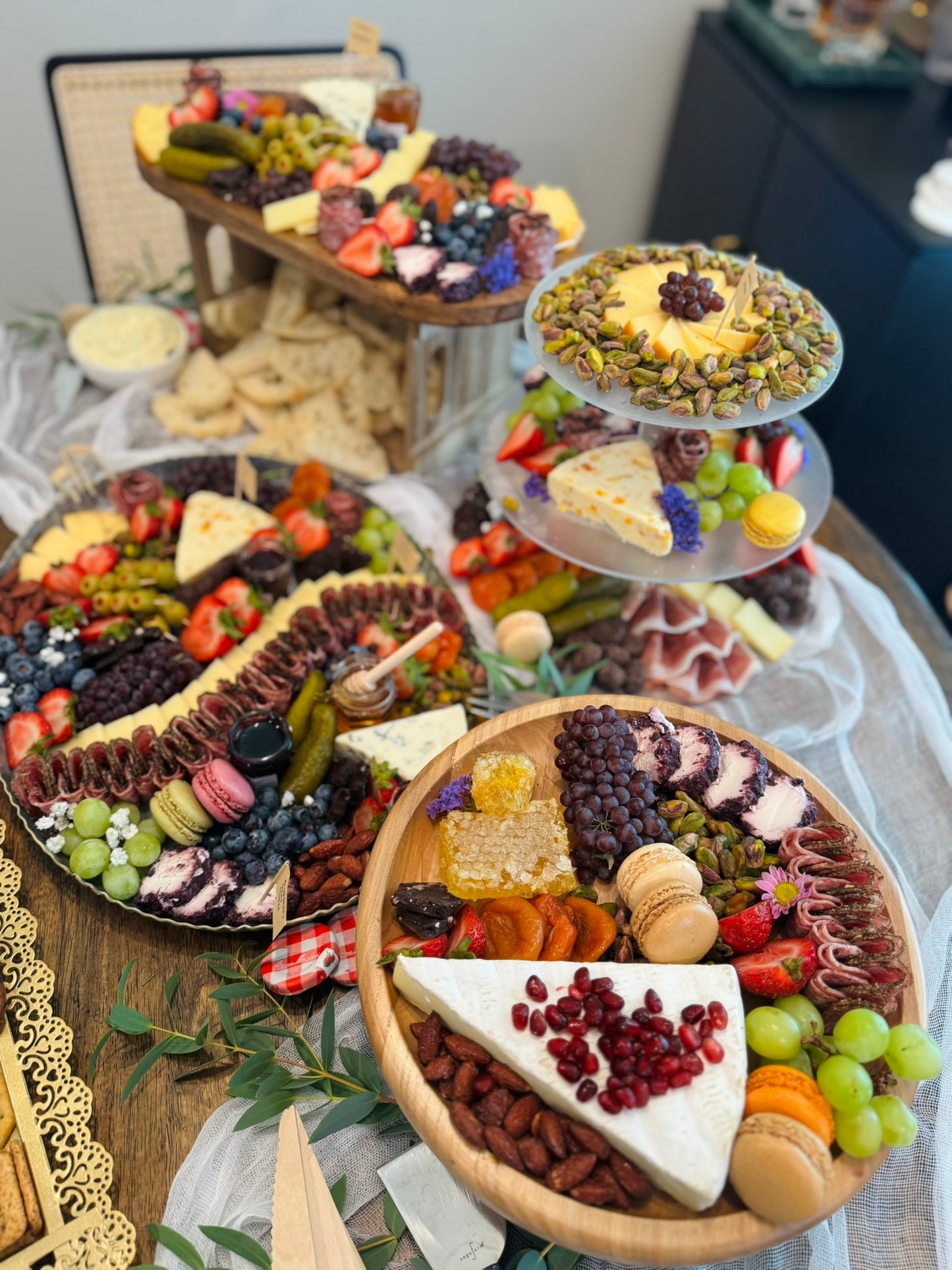 Assorted charcuterie board with fruits, meats, and cheeses on a table.