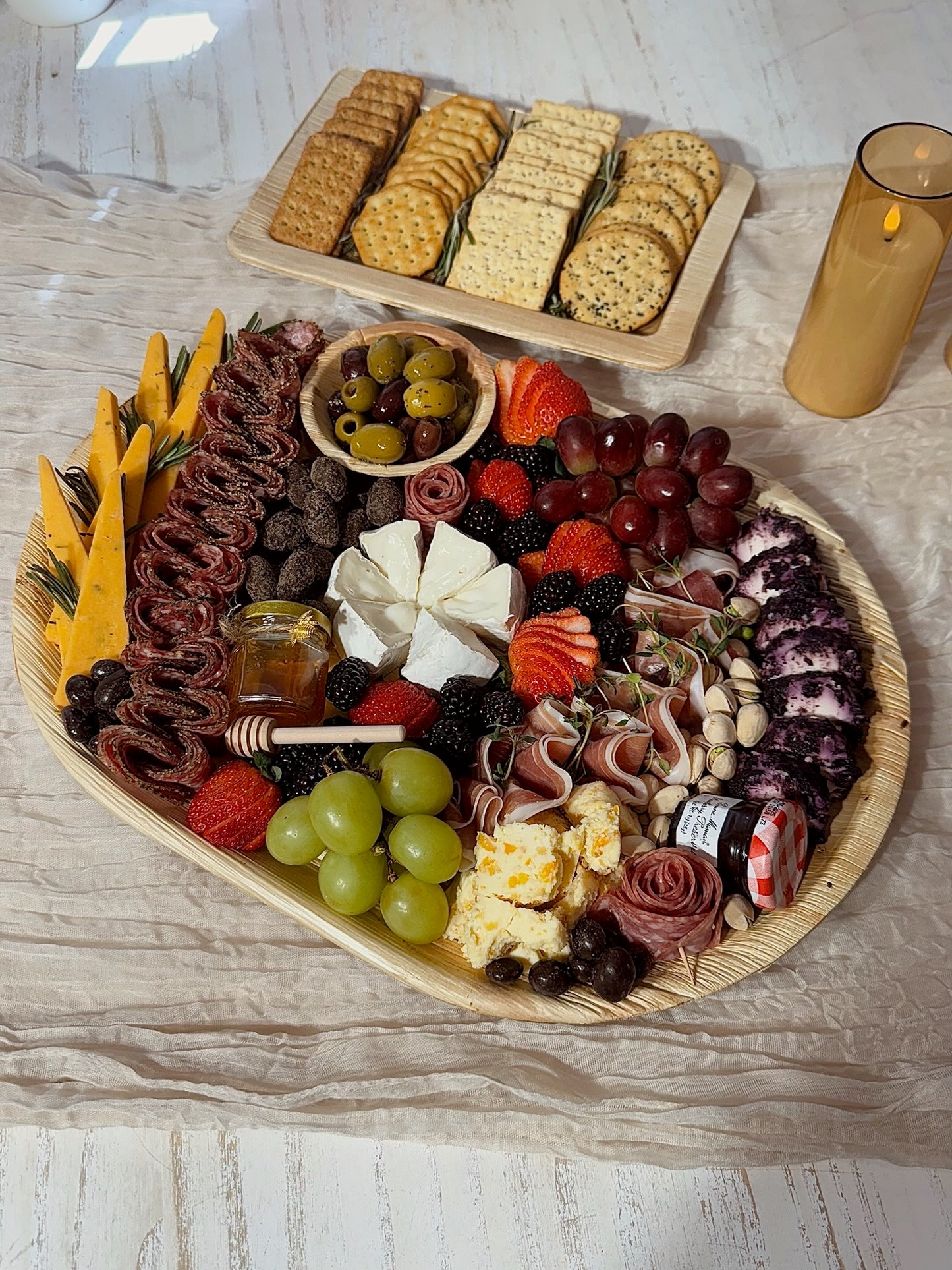 Assorted charcuterie board with meats, cheeses, fruits, and crackers